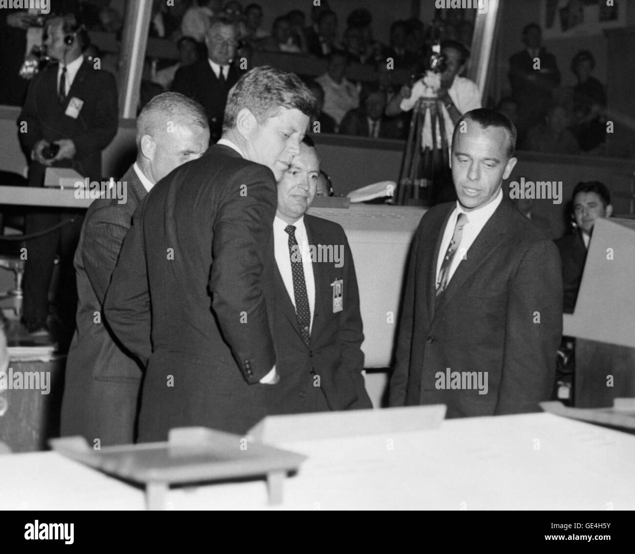 President John F. Kennedy is briefed on the operation of Mercury Control Center at Cape Canaveral following the Mercury-Atlas 6 (MA-6) flight. This was President Kennedy's first visit to Cape Canaveral. MA-6 astronaut John H. Glenn, Jr. (partially obscured) piloted the Mercury &quot;Friendship 7&quot; spacecraft on the United States' first human orbital flight. In the center (on Glenn's left) is Christopher C. Kraft, Jr., MA-6 flight director and Chief of Flight Operations at the Manned Spacecraft Center (MSC). The MA-6 flight was on February 20, 1962. Astronaut Alan B. Shepard, Jr. (right), p Stock Photo