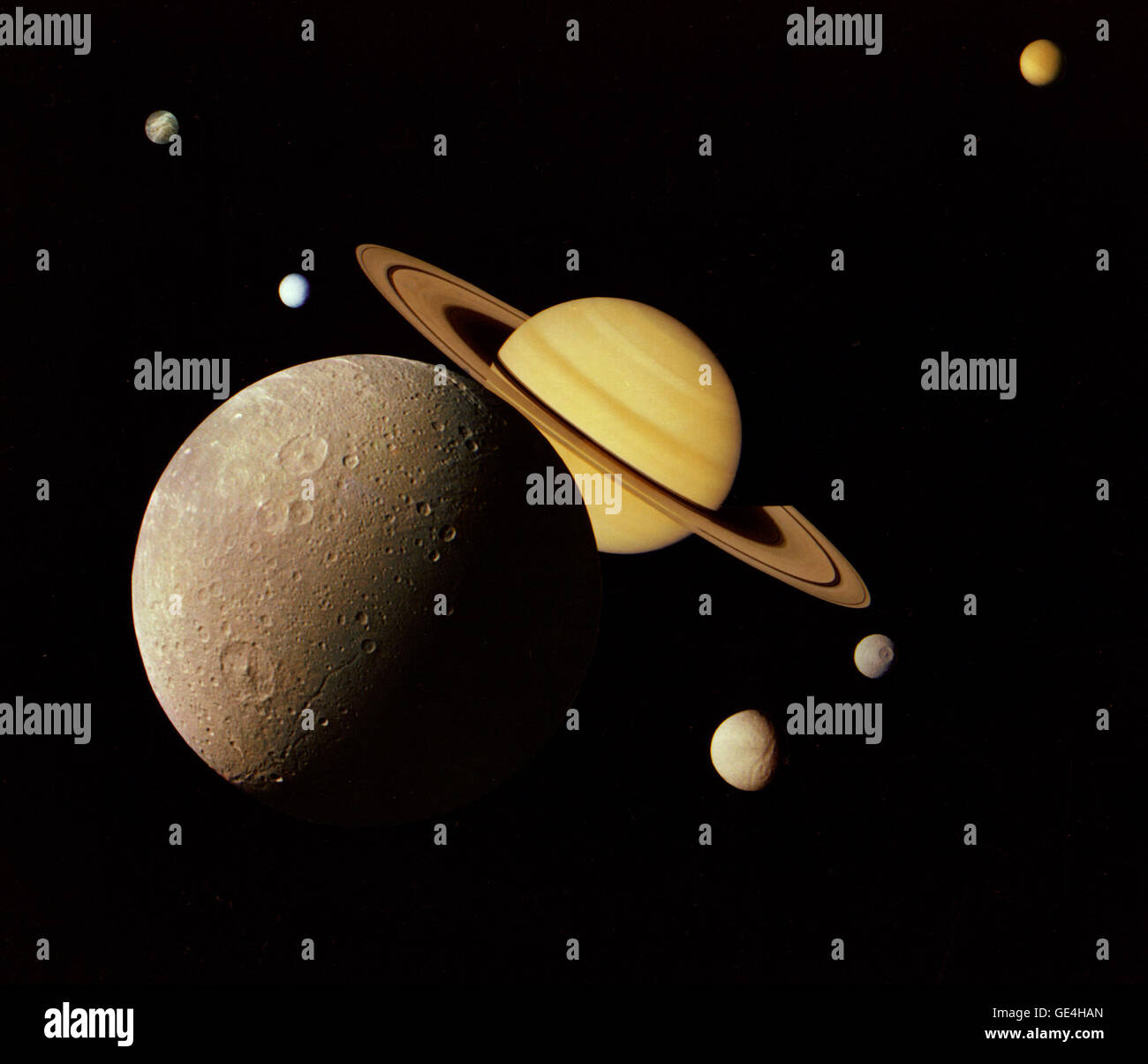 (November 17, 1980) This montage of images of the Saturnian system was prepared from an assemblage of images taken by the Voyager 1 spacecraft during its Saturn encounter in November 1980. This artist's view shows Dione in the forefront, Saturn rising behind, Tethys and Mimas fading in the distance to the right, Enceladus and Rhea off Saturn's rings to the left, and Titan in its distant orbit at the top. The Voyager Project is managed for NASA by the Jet Propulsion Laboratory, Pasadena, California.  Image # : PIA01482 Stock Photo
