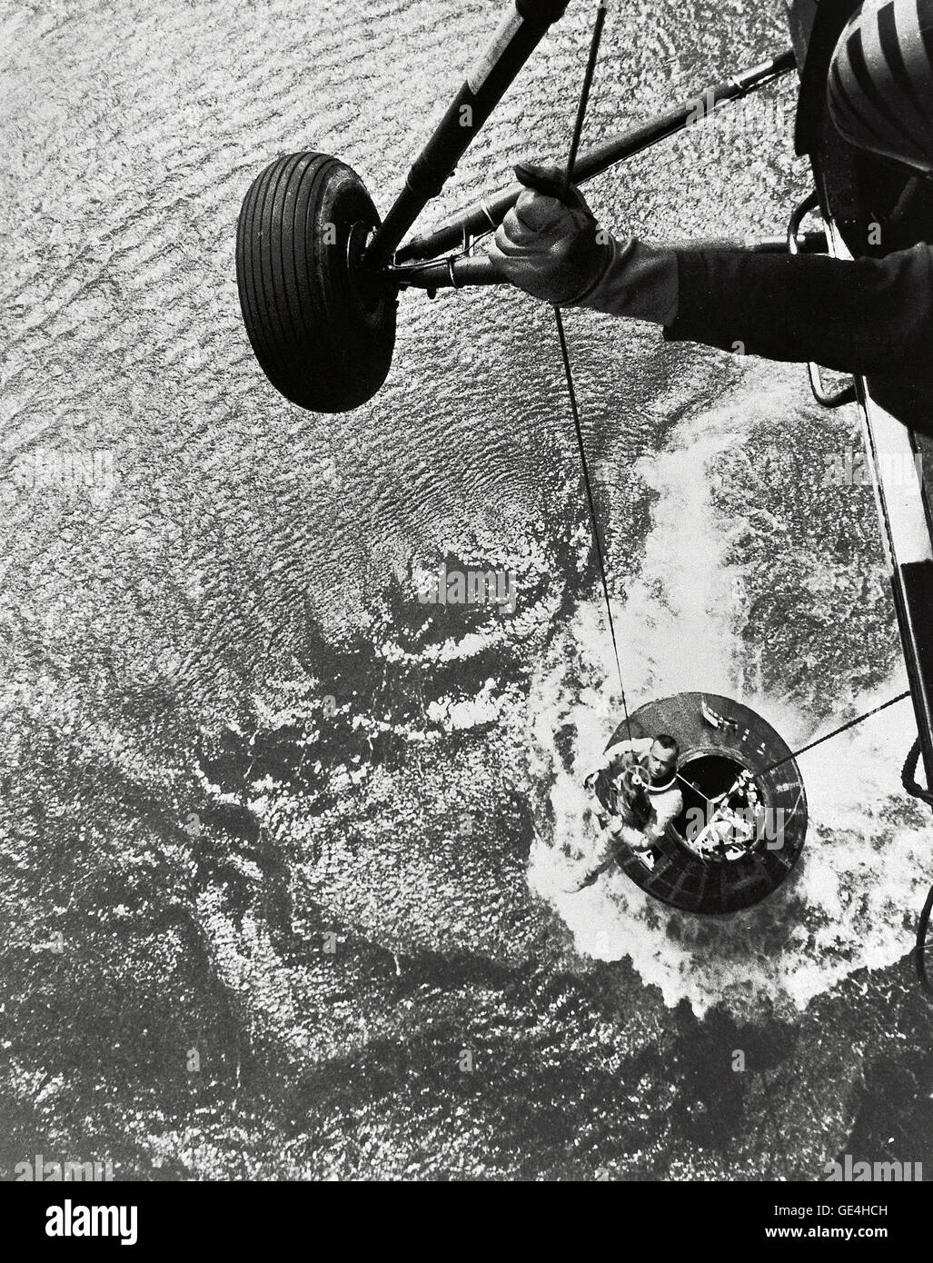A U.S. Marine helicopter recovery team hoists astronaut Alan Shepard from his Mercury spacecraft after a successful flight and splashdown in the Atlantic Ocean. On May 5th 1961, Alan B. Shepard Jr. became the first American to fly into space. His Freedom 7 Mercury capsule flew a suborbital trajectory lasting 15 minutes 22 seconds. His spacecraft landed in the Atlantic Ocean where he and his capsule were recovered by helicopter and transported to the awaiting aircraft carrier U.S.S. Lake Champlain.  Image # : S61-02723 Stock Photo