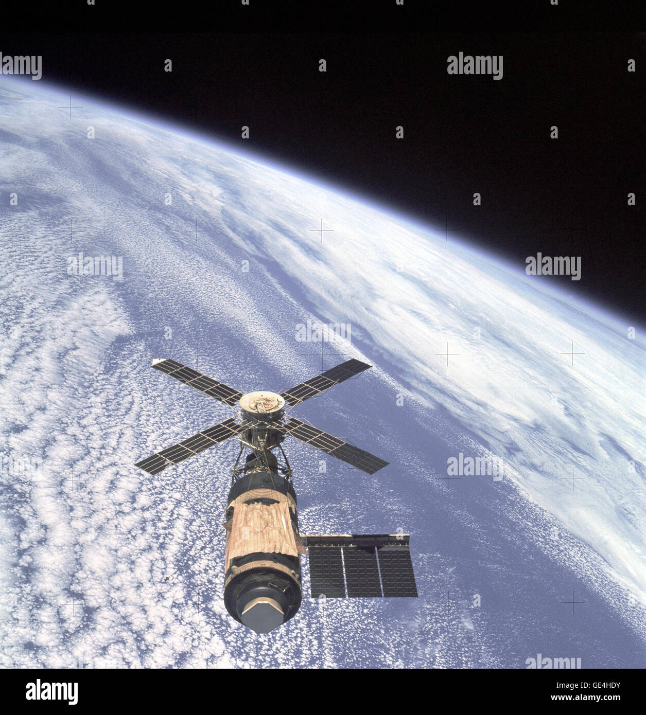 An overhead view of the Skylab Orbital Workshop in Earth orbit as photographed from the Skylab 4 Command and Service Modules (CSM) during the final fly-around by the CSM before returning home. The space station is contrasted against the pale blue Earth. During launch on May 14, 1973, some 63 seconds into flight, the micrometeor shield on the Orbital Workshop (OWS) experienced a failure that caused it to be caught up in the supersonic air flow during ascent. This ripped the shield from the OWS and damaged the tie downs that secured one of the solar array systems. Complete loss of one of the sol Stock Photo