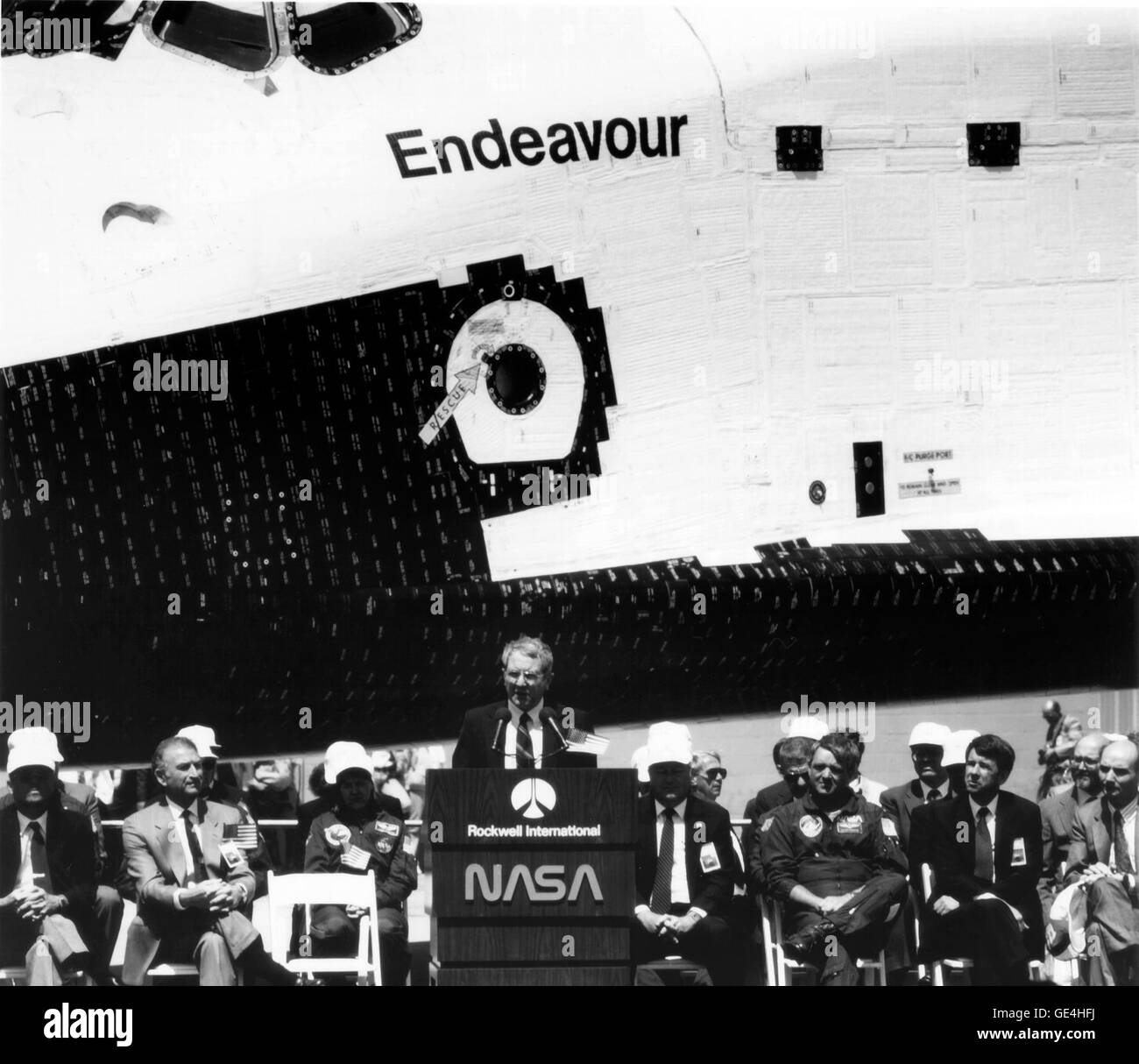 NASA Administrator Richard H. Truly addresses the audience in attendance at the rollout ceremonies of the Space Shuttle Orbiter Endeavour which occured on April 25, 1991, at the Rockwell International facility, Palmdale, Calif. Endeavour, the fourth Orbiter to join the fleet, replacing the lost Challenger, can be seen in the background.   Image # : 91-H-323  Date: April 15, 1991 Stock Photo