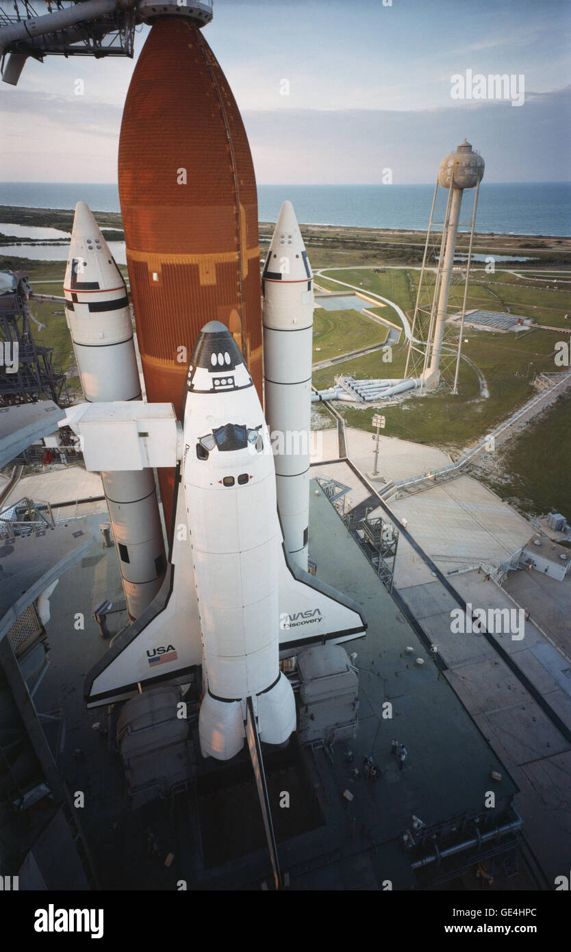 In this picture, Space Shuttle Discovery sits on Launch Pad 39A prior to the launch of its STS-41D mission. Scheduled to launch on June 26, 1984, the launch was aborted due to a hydrogen fire on the launch pad. This was the first launch pad abort of the Shuttle Program.  Image # : ksc-84pc-476 Date: August 29, 1984 Stock Photo