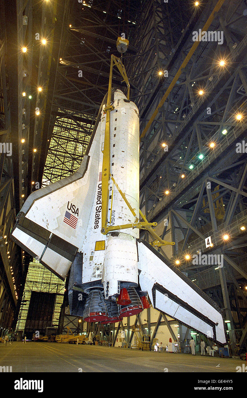 Inside the cavernous Vehicle Assembly Building, workers carry out the meticulous process of lifting the orbiter Discovery from a horizontal to a vertical position. Once upright, Discovery will be transferred into a high bay for mating with the external tank/solid rocket booster assembly aready mounted on the mobile launch platform. Completing the assembly process takes about five working days. Discovery's next destination: Launch Pad 39B, and final preparations for liftoff on Mission STS-70 in early June.   Image # : 95PC-0645 Stock Photo