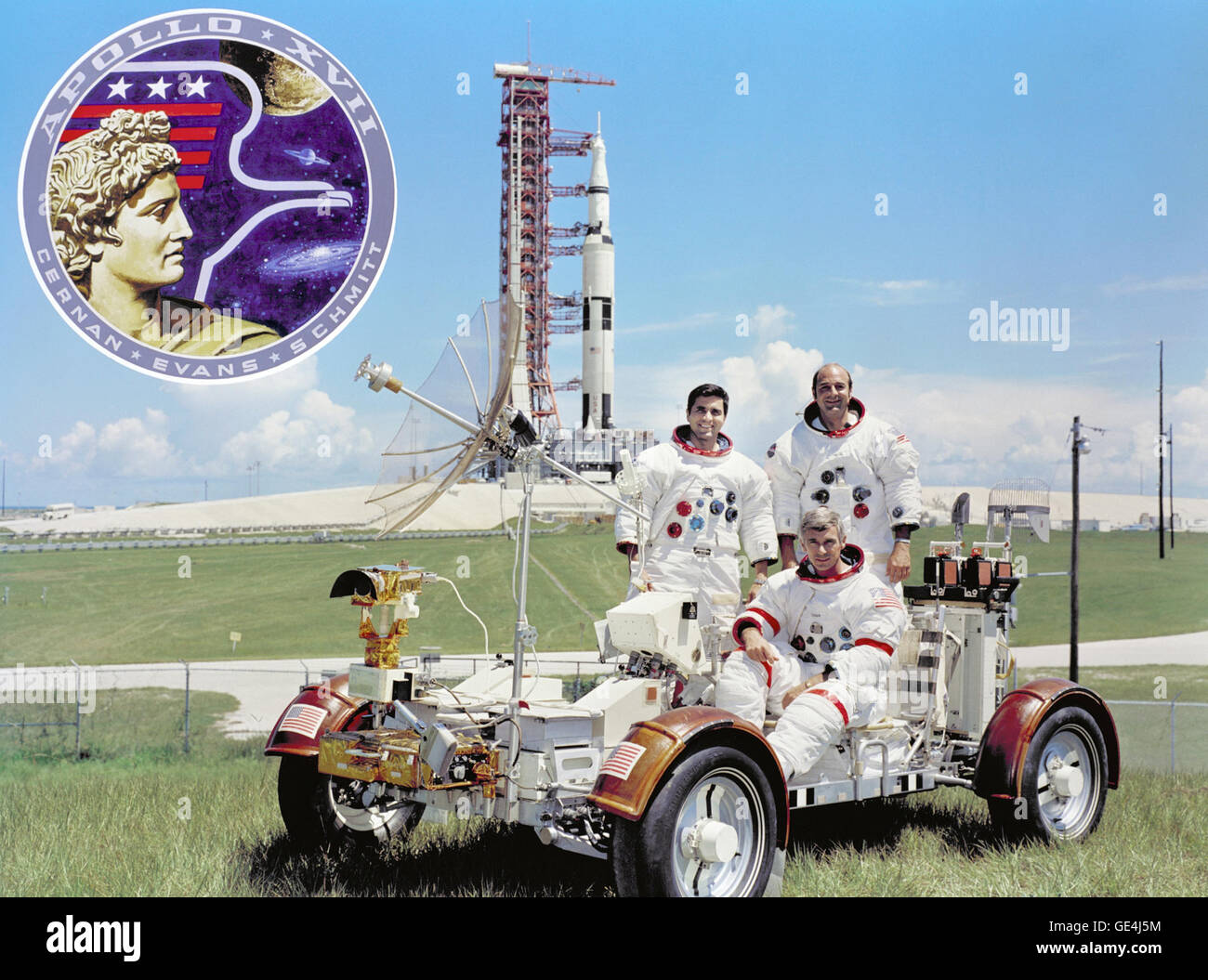 (September 30, 1972) The prime crew for the Apollo 17 lunar landing mission are: Commander, Eugene A. Cernan (seated), Command Module pilot Ronald E. Evans (standing on right), and Lunar Module pilot, Harrison H. Schmitt. They are photographed with a Lunar Roving Vehicle (LRV) trainer. Cernan and Schmitt will use an LRV during their exploration of the Taurus-Littrow landing site. The Apollo 17 Saturn V Moon rocket is in the background. This picture was taken at Pad A, Launch Complex 39, Kennedy Space Center (KSC), Florida, The Apollo 17 emblem is in the photo insert at upper left. Apollo 17 la Stock Photo