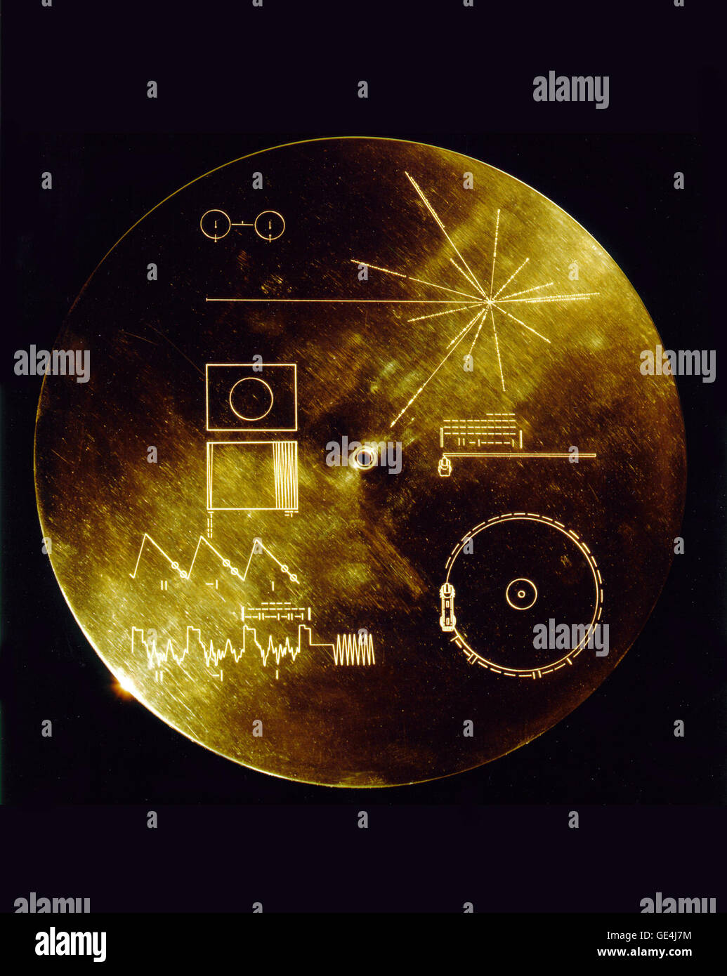 This gold aluminum cover was designed to protect the Voyager 1 and 2 &quot;Sounds of Earth&quot; gold-plated records from micrometeorite bombardment, but also serves a double purpose in providing the finder a key to playing the record. The explanatory diagram appears on both the inner and outer surfaces of the cover, as the outer diagram will be eroded in time. Flying aboard Voyagers 1 and 2 are identical &quot;golden&quot; records, carrying the story of Earth far into deep space. The 12 inch gold-plated copper discs contain greetings in 60 languages, samples of music from different cultures a Stock Photo