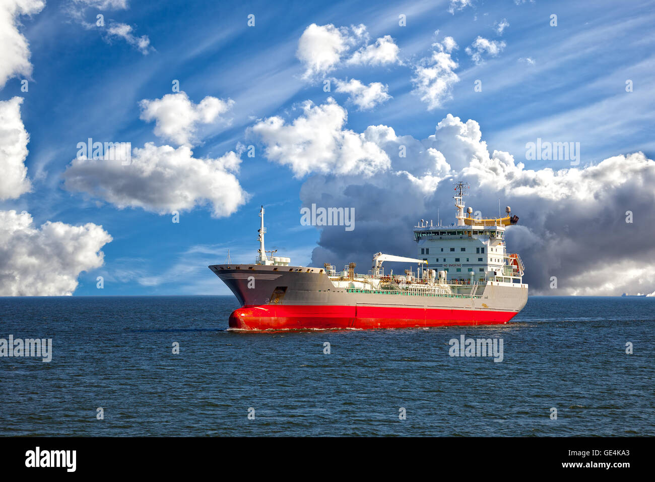 Oil tanker ship at sea on a background of blue sky Stock Photo - Alamy