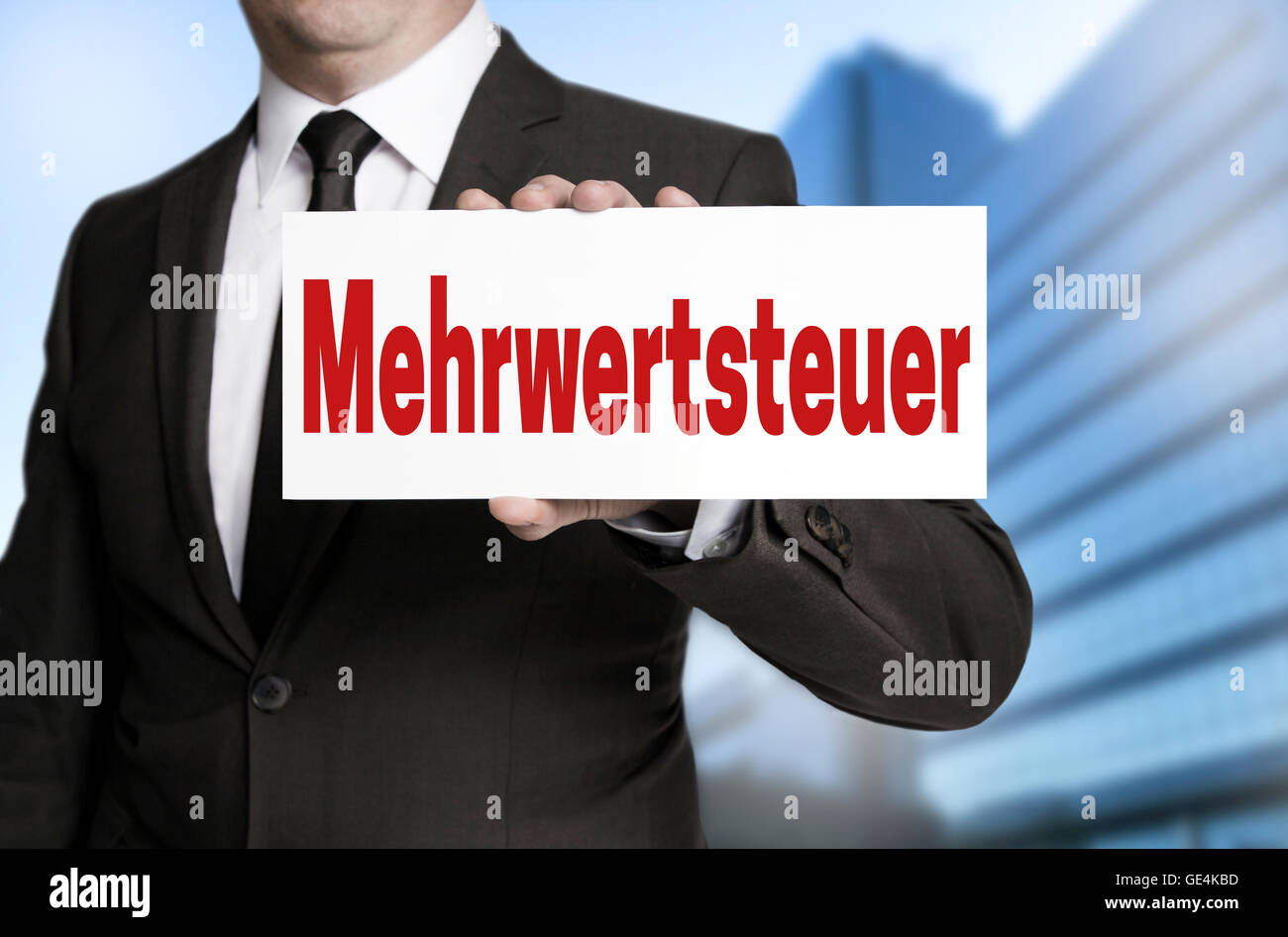Mehrwertsteuer (in german VAT) sign is held by businessman. Stock Photo
