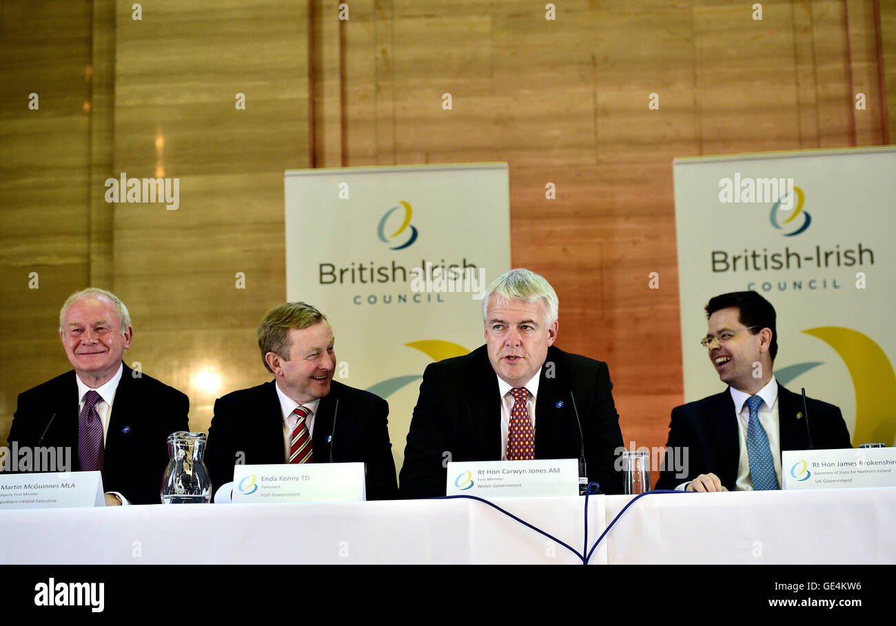 Wales First Minister Carwyn Jones, second right, cracks a joke as he is asked a question in Welsh as Northern Ireland Deputy First Minister Martin McGuinness, left, Irish Taoiseach Enda Kenny, second left, and Secretary of State for Northern Ireland James Brokenshire laugh during a press conference following an emergency meeting of the British Irish Council, at the Temple of Peace, Cardiff. Stock Photo