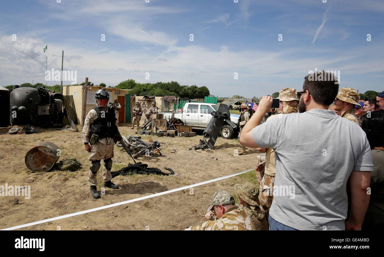 Members of the Three Sixty History Group re-enact a 1993 U.S Military battle within a full scale setting of a Black-Hawk helicopter crash at the Battle of Mogadishu, as the War and Peace Revival continues near Folkestone, Kent. Stock Photo