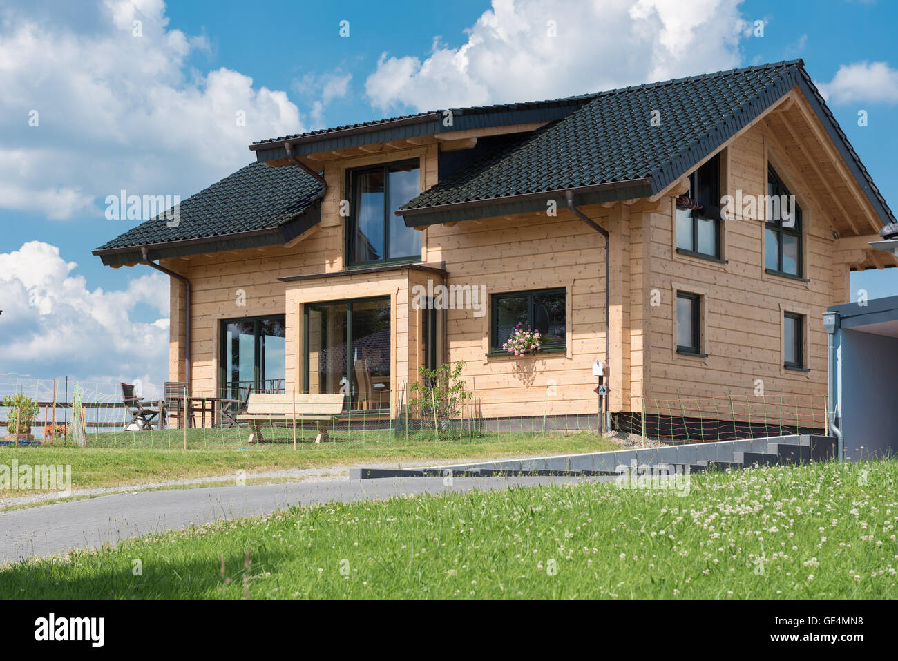 beautiful prefabricated house with meadow under blue sky Stock Photo