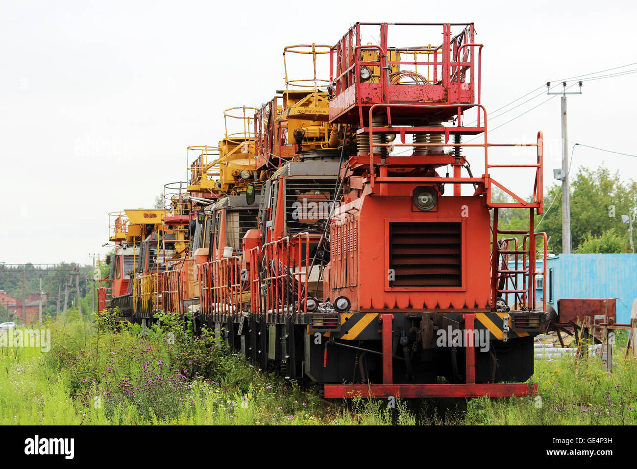 Railway heavy duty machines train entering the station Stock Photo