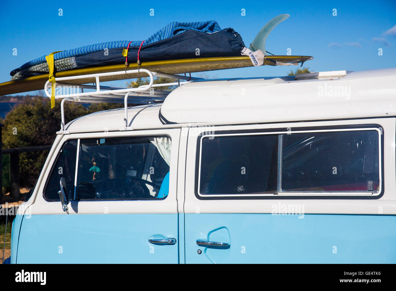 Close up surfboard mounted on the roof of a classic kombi van in Sydney ...