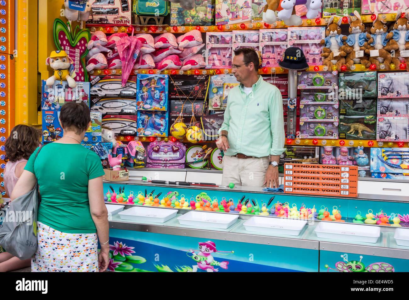 Toys on display as prizes at Hook-a-duck / Duck Pond Game, traditional fairground stall game at travelling funfair Stock Photo