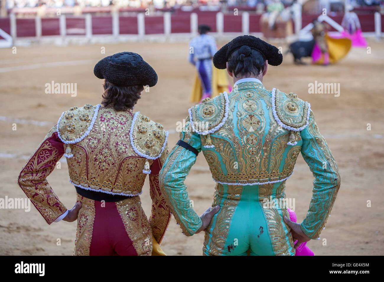 Spanish Bullfighters looking bullfighting, the Bullfighter on the left dressed in suit of lights of colors red and gold and the Stock Photo