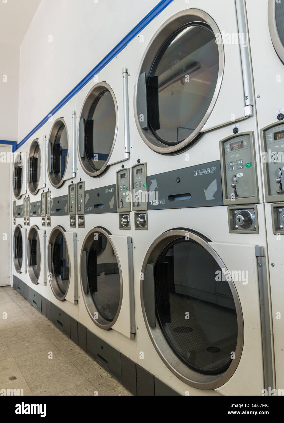 industrial laundry machines in laundrette Stock Photo