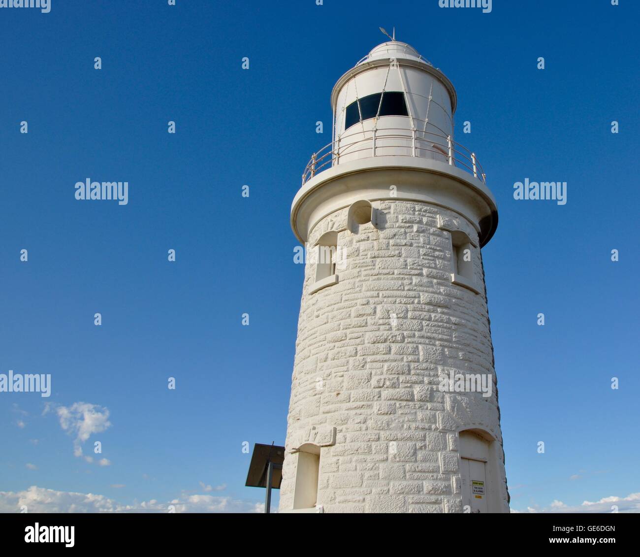 White painted limestone Woodman Point Lighthouse with a bright blue sky