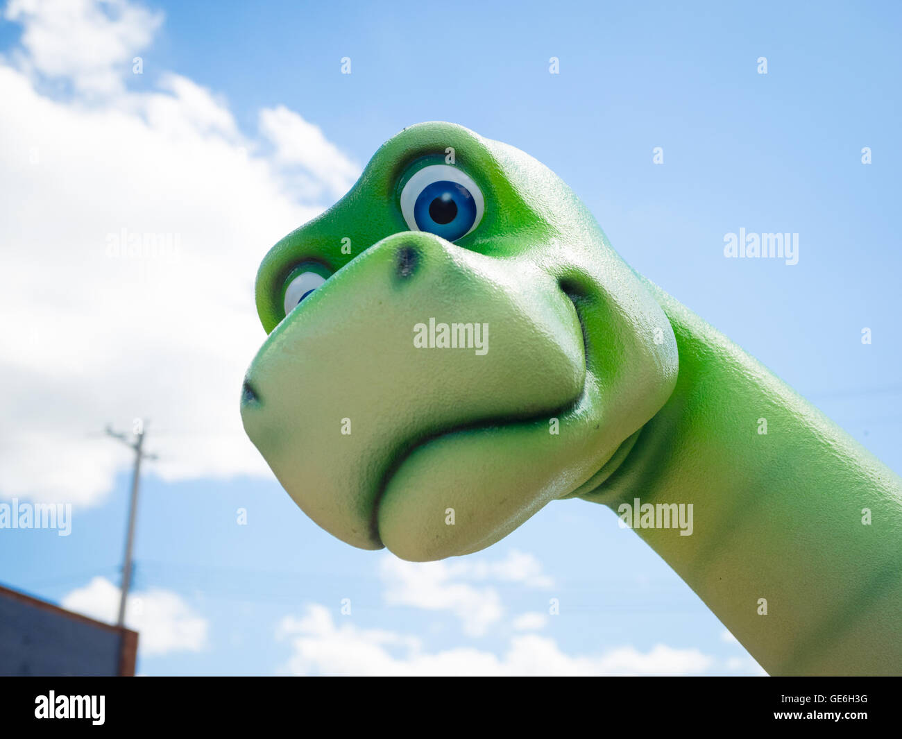 A friendly green dinosaur statue in the town of Drumheller, Alberta, Canada. Stock Photo