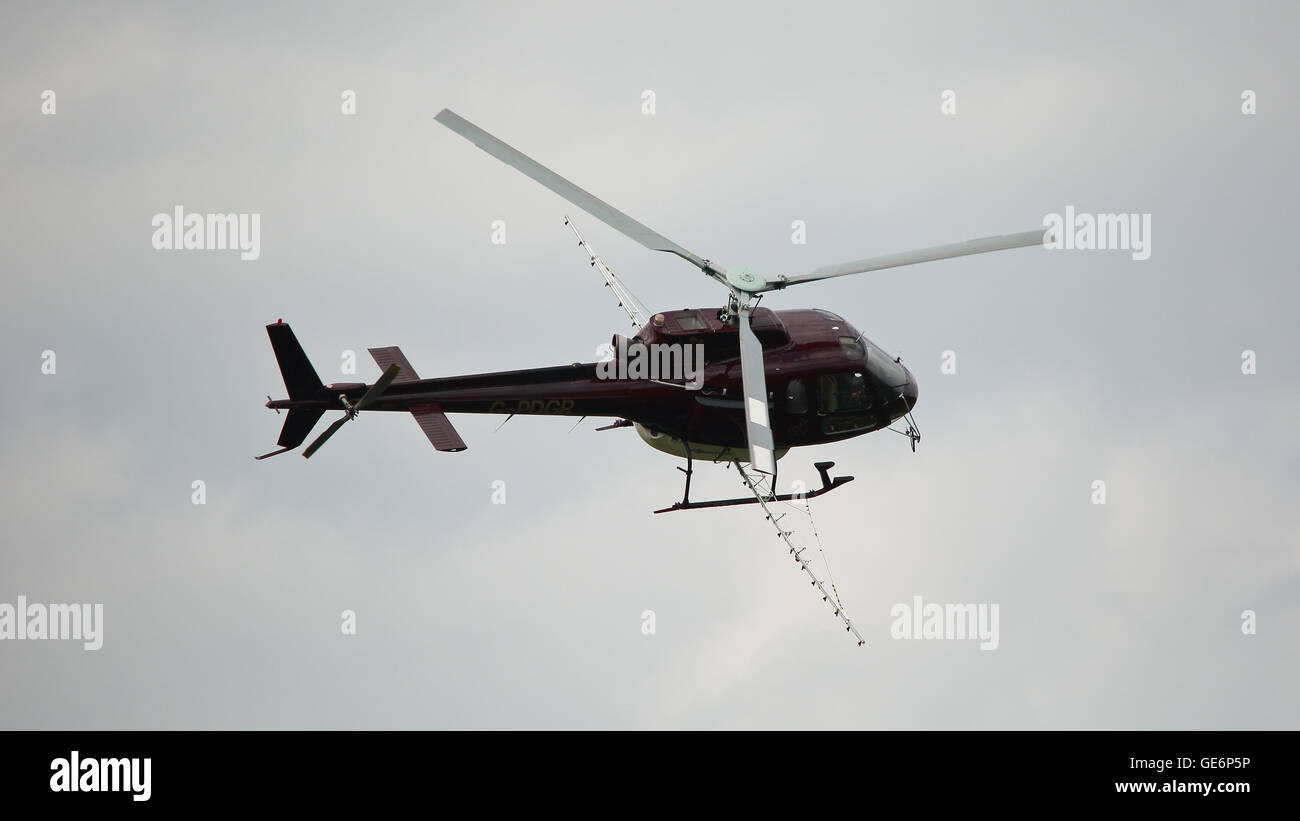 Helicopter in flight ready to spray pesticide and fertilizer Stock
