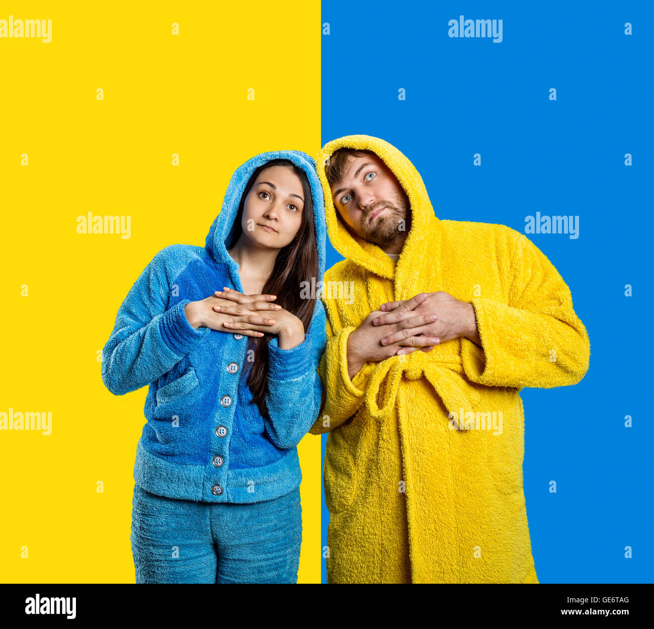 Couple wearing blue pijamas and yellow bathrobe Stock Photo Alamy