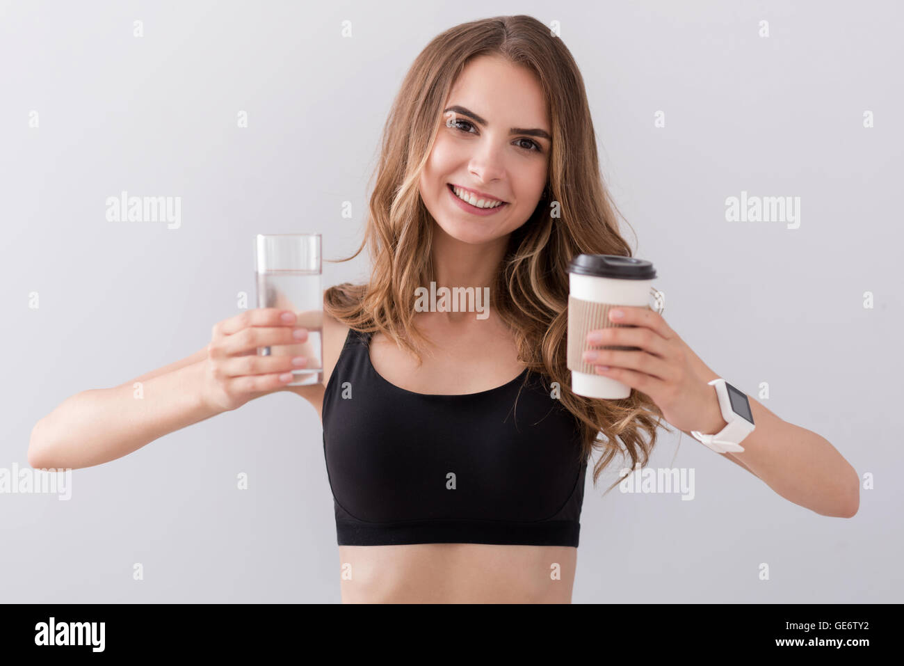 Positive smiling woman holding drinks Stock Photo