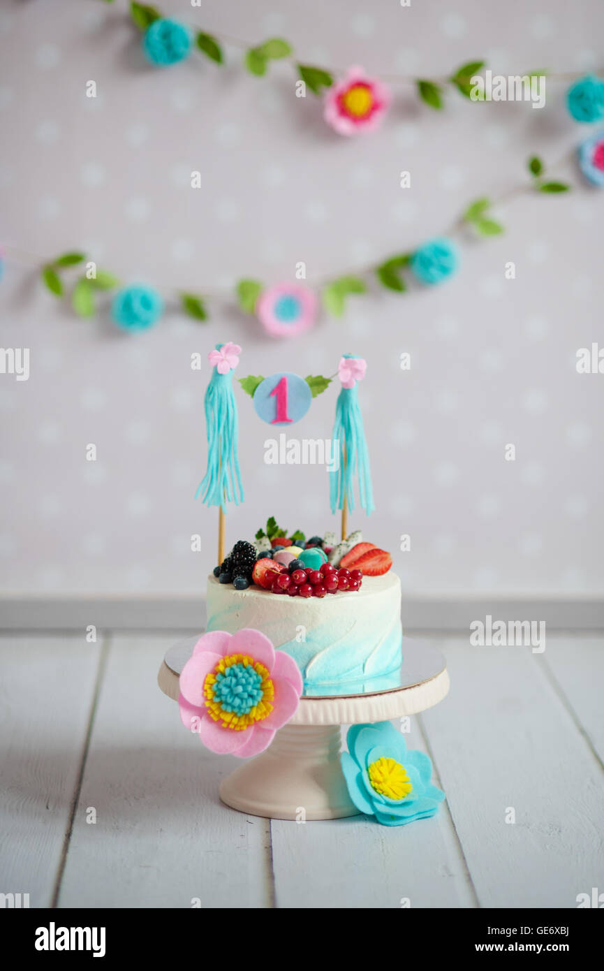 Birthday cake decorated with fruits and a garland Stock Photo