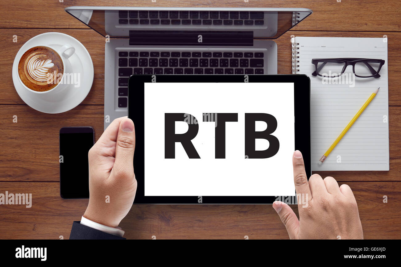 RTB , on the tablet pc screen held by businessman hands - online, top view Stock Photo