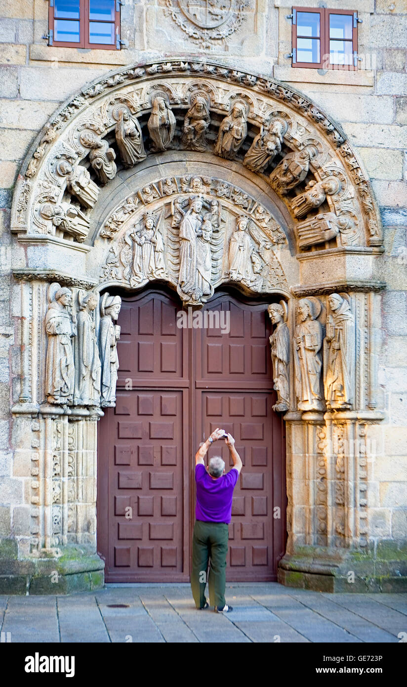 Tourist photographing the principal door of Colexio de San Xerome in Plaza do Obradoiro . Santiago de Compostela. A Coruña provi Stock Photo