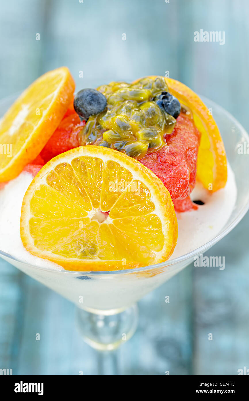Strawberry sorbet and tropical fruits on ice cream Stock Photo