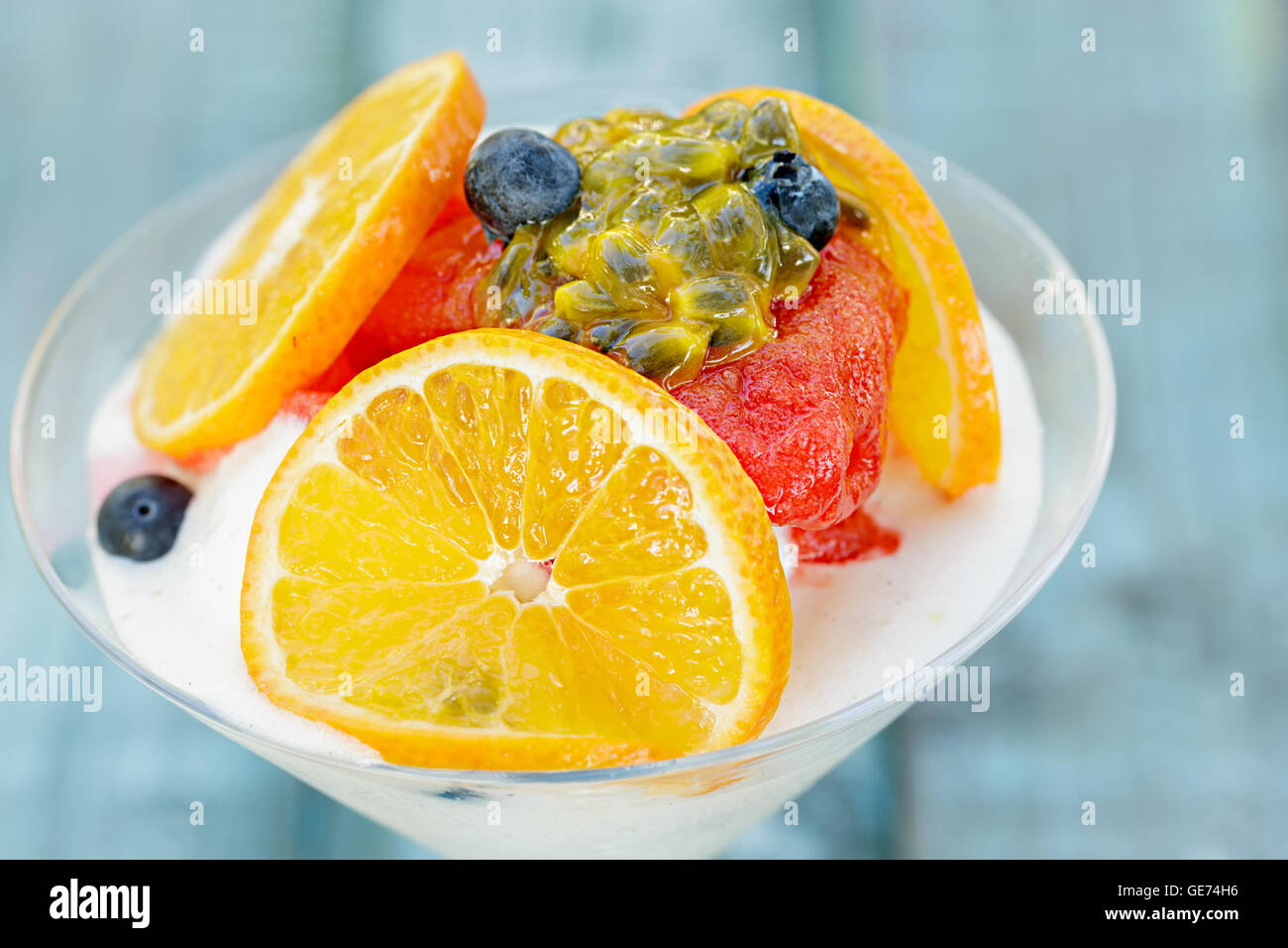 Strawberry sorbet and tropical fruits on ice cream Stock Photo