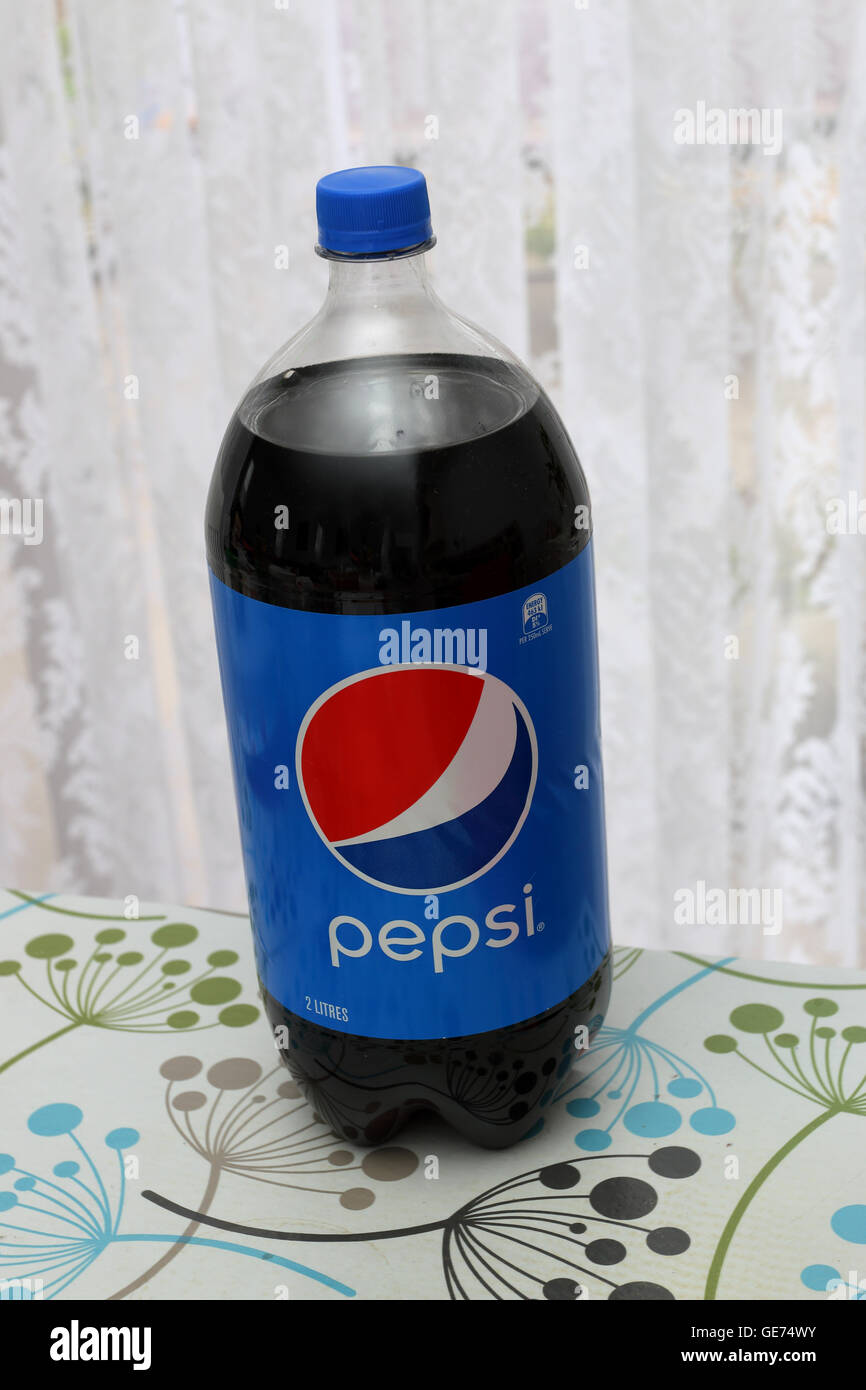A bottle on unopened Pepsi drink on a table Stock Photo