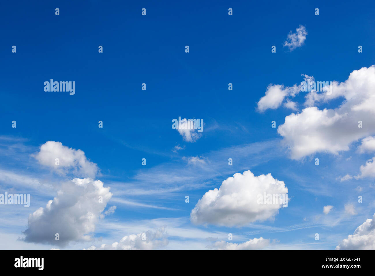 Beautiful summer sky background with fluffy white clouds on blue. Stock Photo