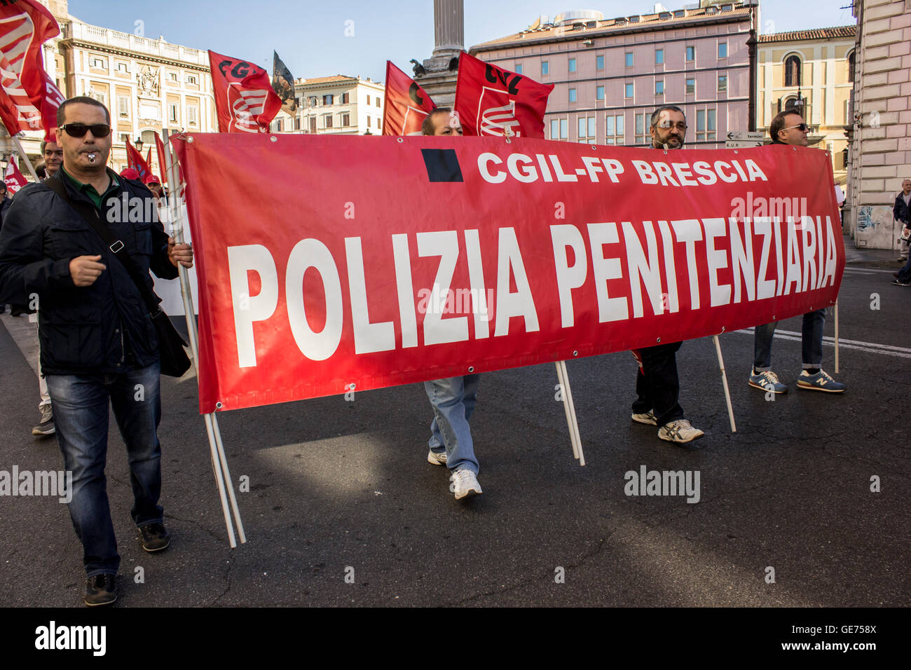 Protesters hold up the banner of the police prison - CGIL section of Brescia Stock Photo