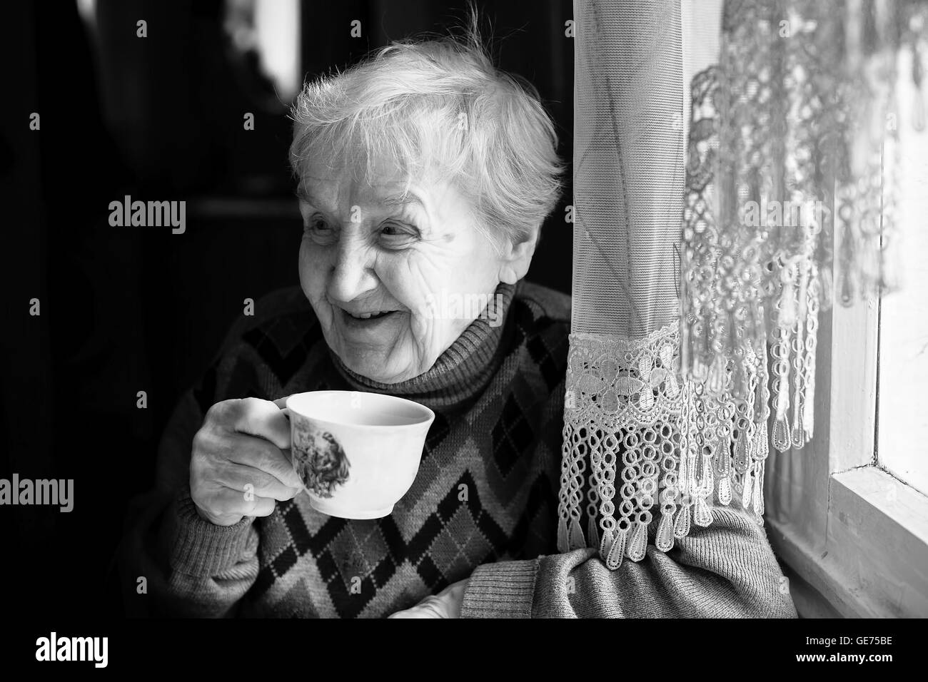 Elderly woman drinking tea. Black and white photo Stock Photo Alamy