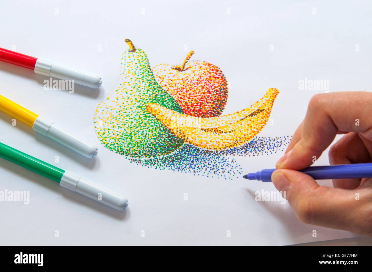 Man's hand drawing a still life using color markers. Pointillism technique. Stock Photo