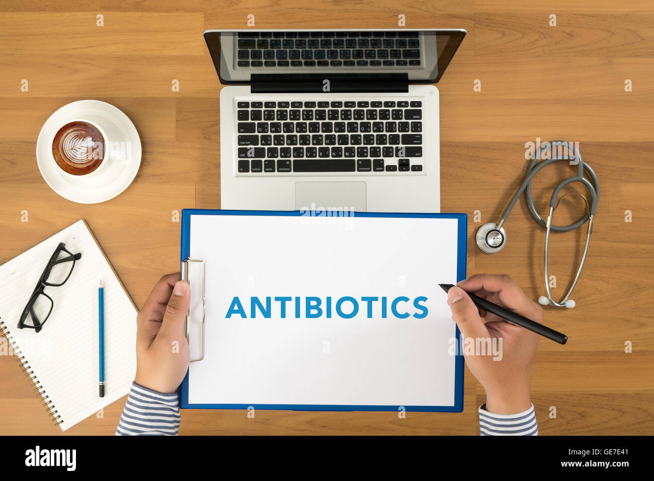 ANTIBIOTICS CONCEPT Doctor writing medical records on a clipboard