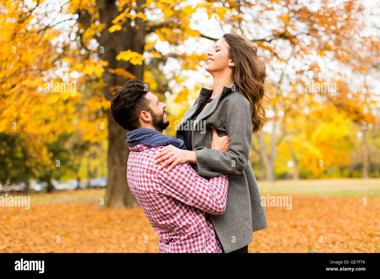 Loving young couple in the autumn park Stock Photo - Alamy