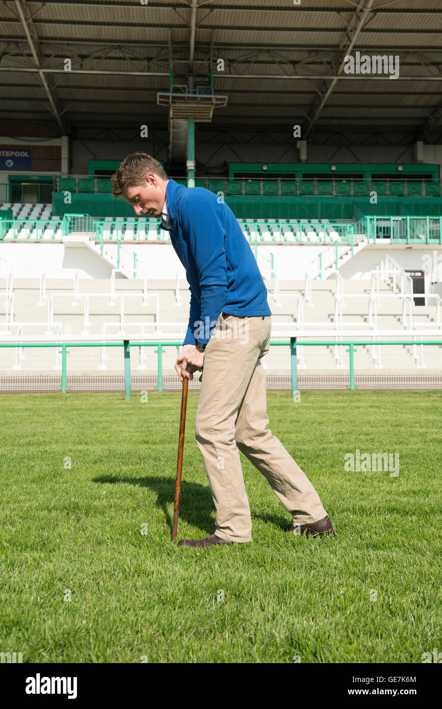 The head grounds man at Brighton Race course checks the ground & the going for the upcoming horse race with specialist equipment Stock Photo