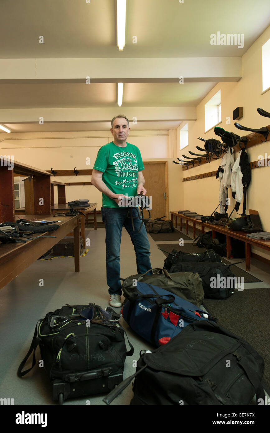 horse racing locker room, stud room where the jockeys change into their outfits with a locker room attendant and saddles Stock Photo