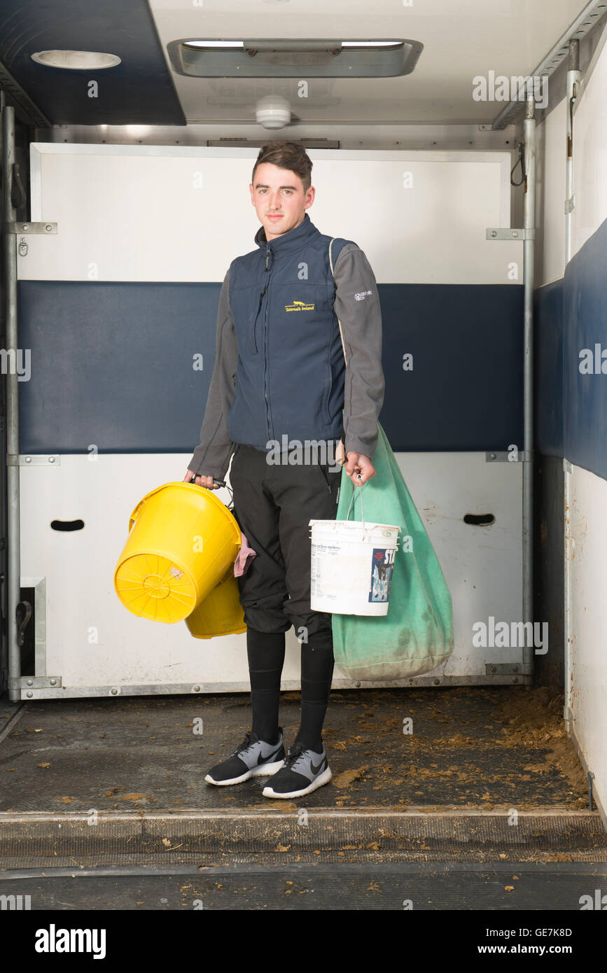 kit boy in a horse box carrying the food and buckets needed to look after the horses at Brighton