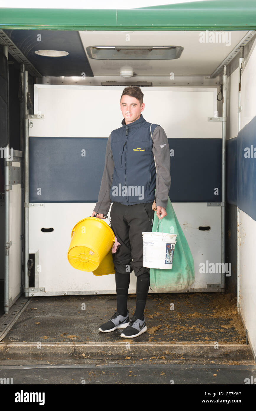 kit boy in a horse box carrying the food and buckets needed to look after the horses at Brighton