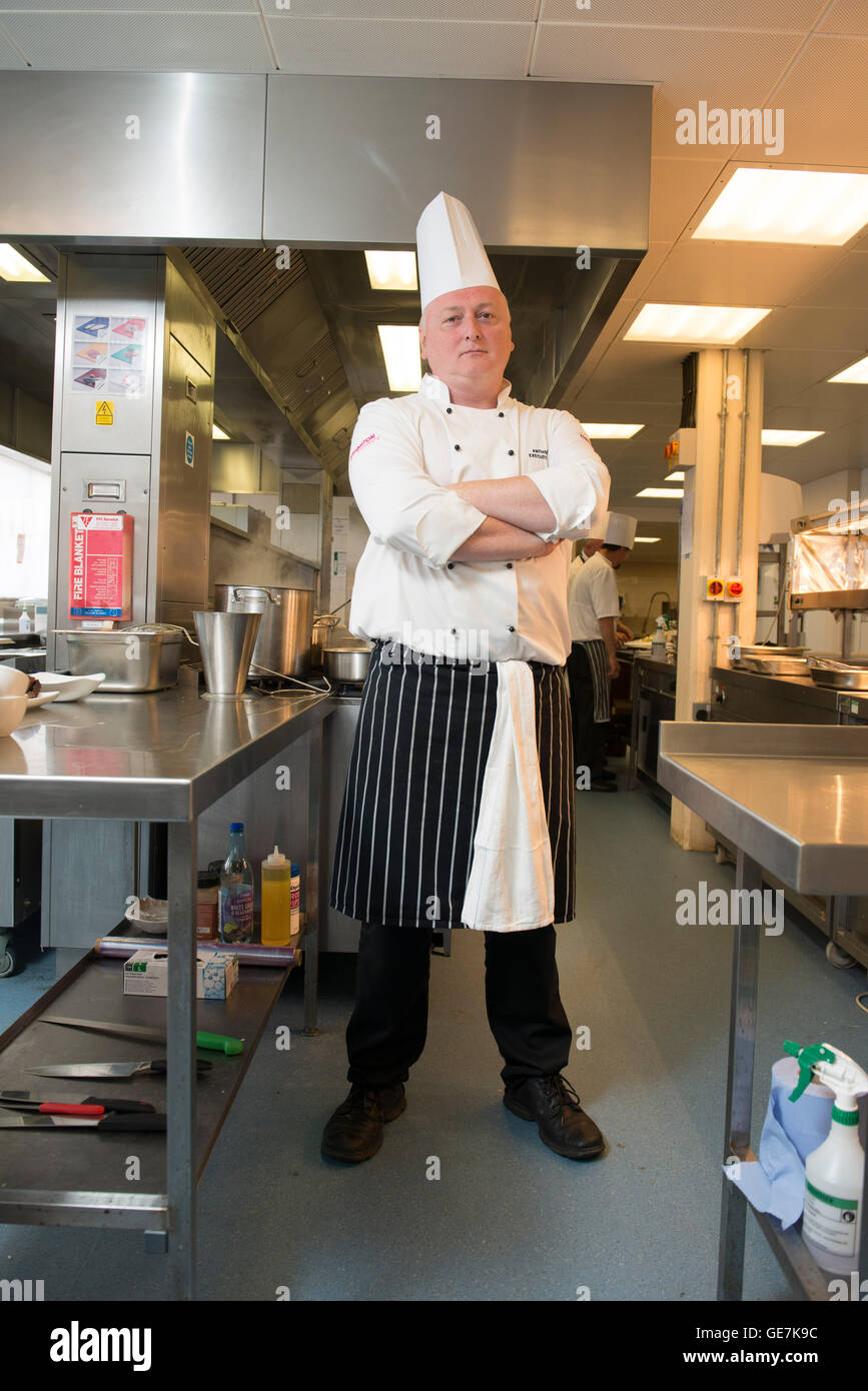 Head chef at Brighton Race course stands in his kitchen in typical chef poses Stock Photo Alamy