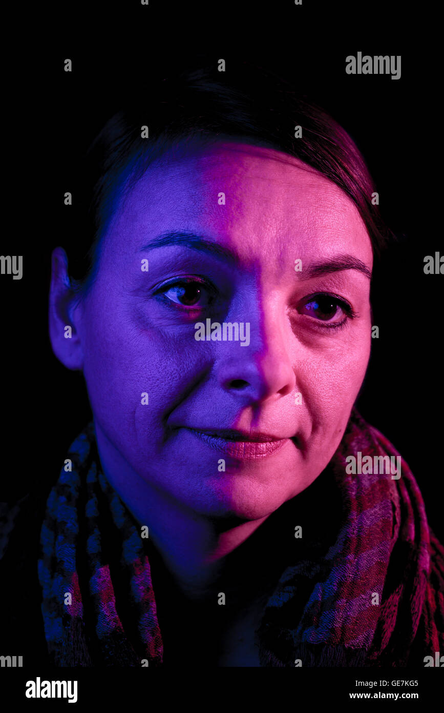 womans face lit by coloured light Stock Photo - Alamy