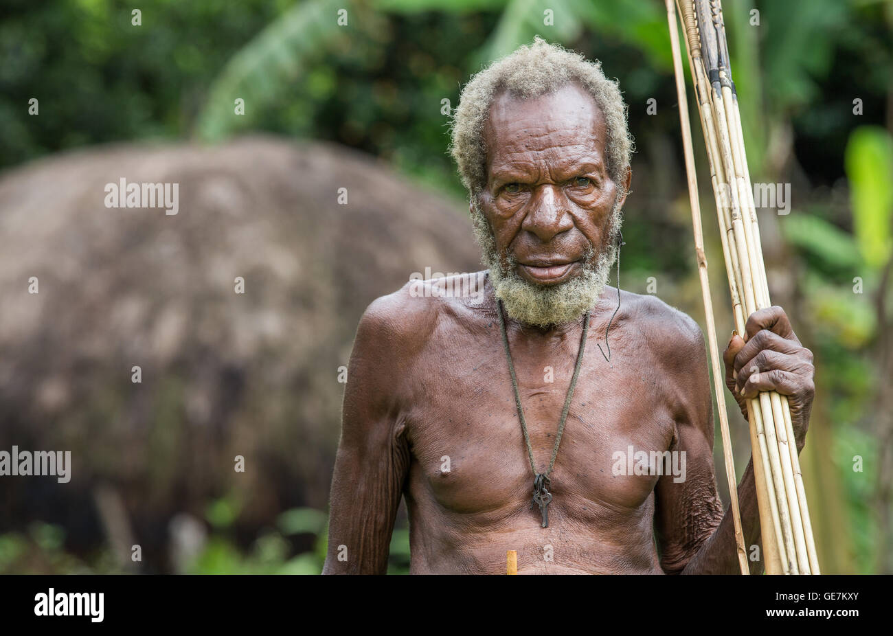 Ugem village, Baliem Valley, West Papua, Indonesia - February 13th 2016: Dani tribe man with a bow and arrows Stock Photo