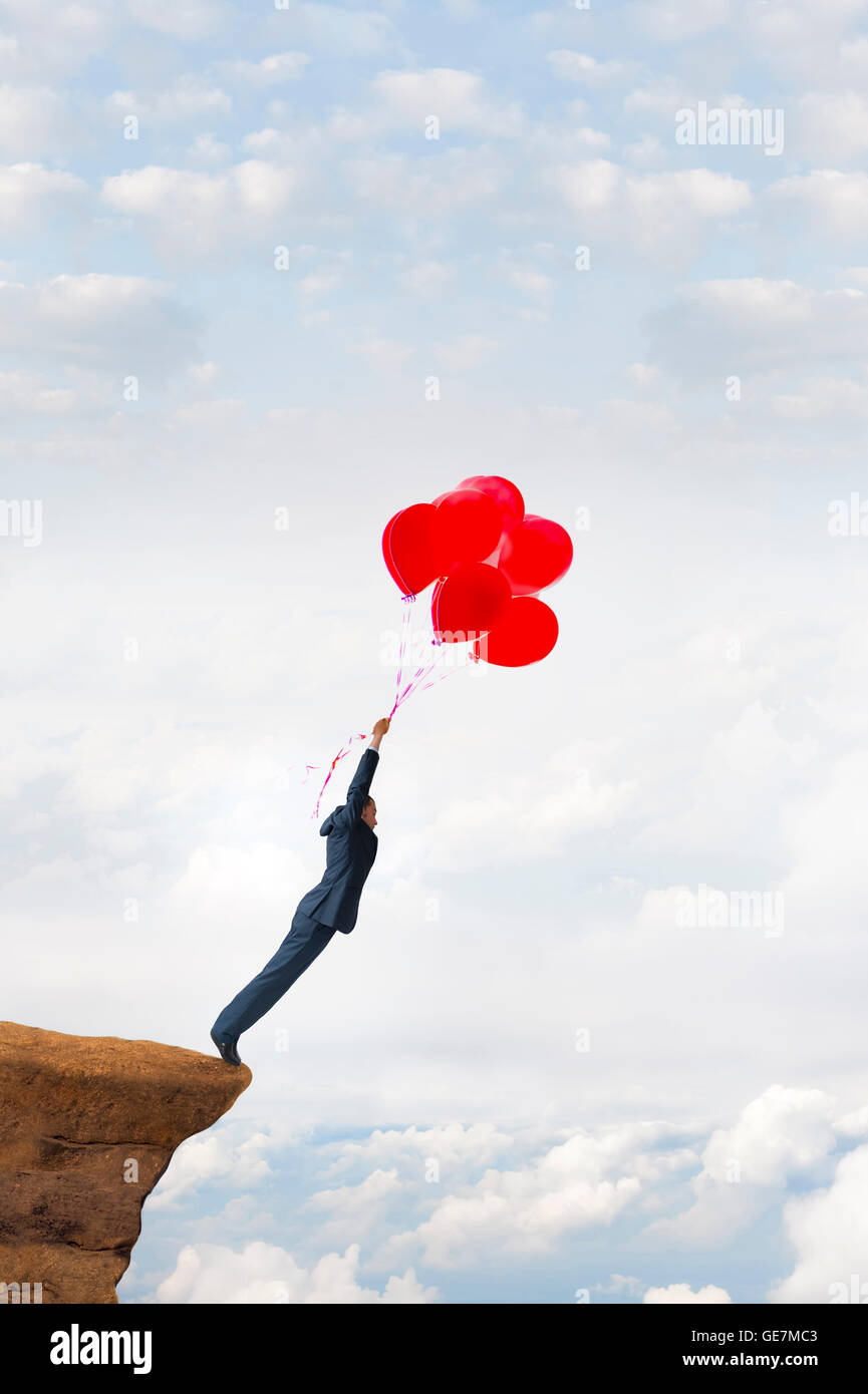 business risk concept courageous daring businessman holding balloons Stock Photo
