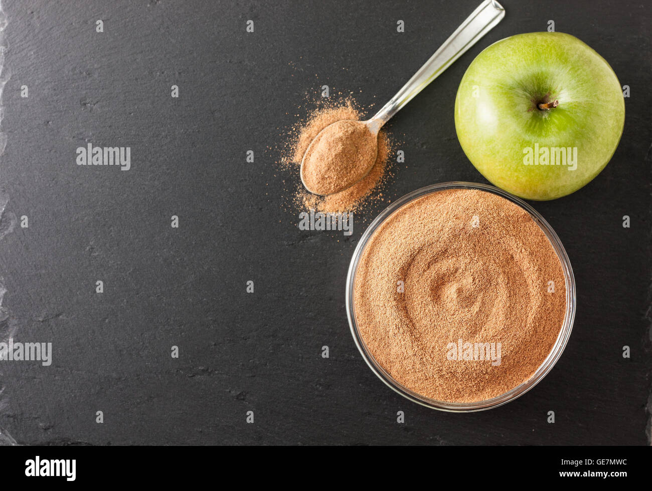 crushed apple fiber, apple green on a black background with space for text (top view). dietary product Stock Photo