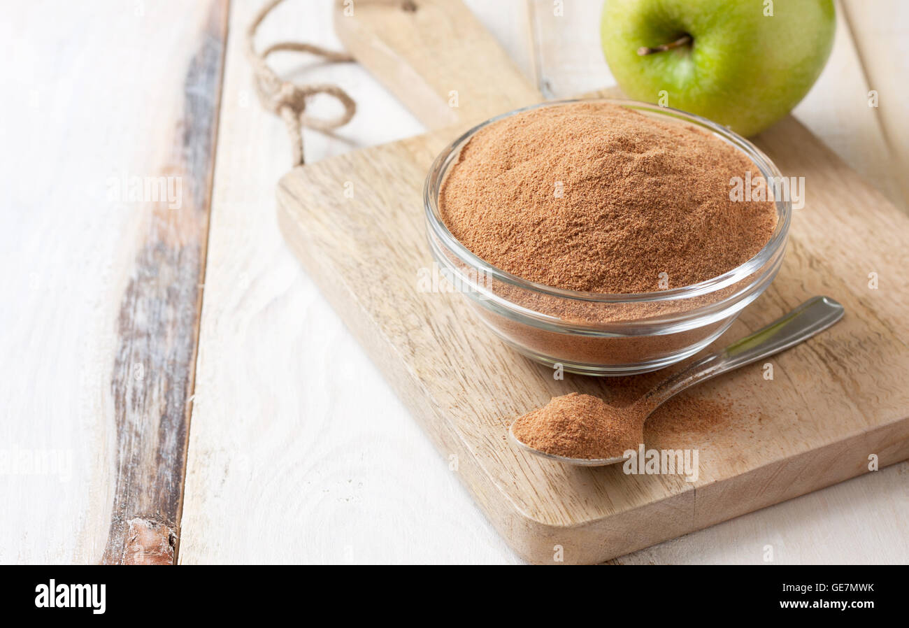 crushed apple fiber, green apples on a light wooden background. dietary product Stock Photo