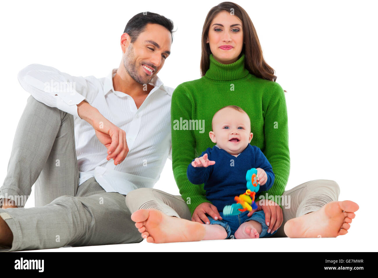 A photo of happy parents with baby boy. Family of three are spending leisure time together. They are in casuals isolated over wh Stock Photo