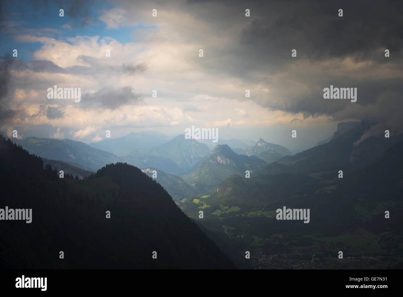 Dramatic sky with sun and rain clouds over Lofer town and Reiteralpe mountains in the European Alps, Salzburg, Austria Stock Photo