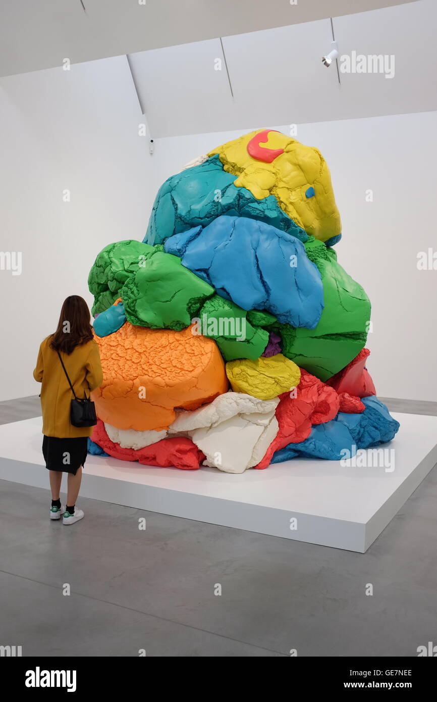 woman viewing Jeff Koons' 'Play doh' sulpture at Damien Hirst's Newport