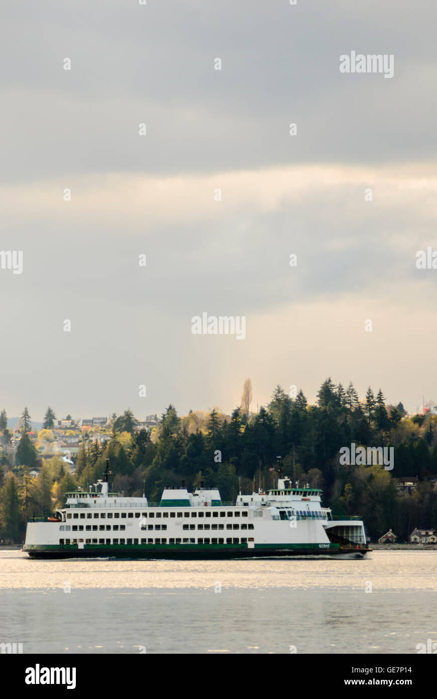 The MV Kitsap ferry sailing between Seattle and Bremerton.  Bainbridge Island is in the background. Stock Photo